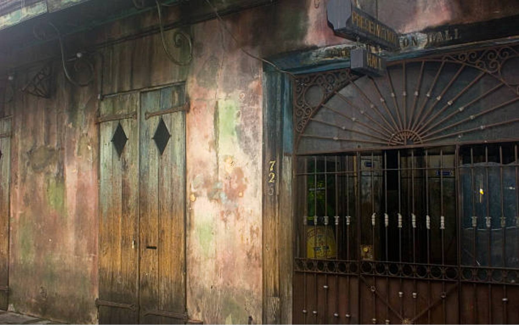A weathered storefront in the French Quarter of New Orleans with a sign reading Preservation Hall